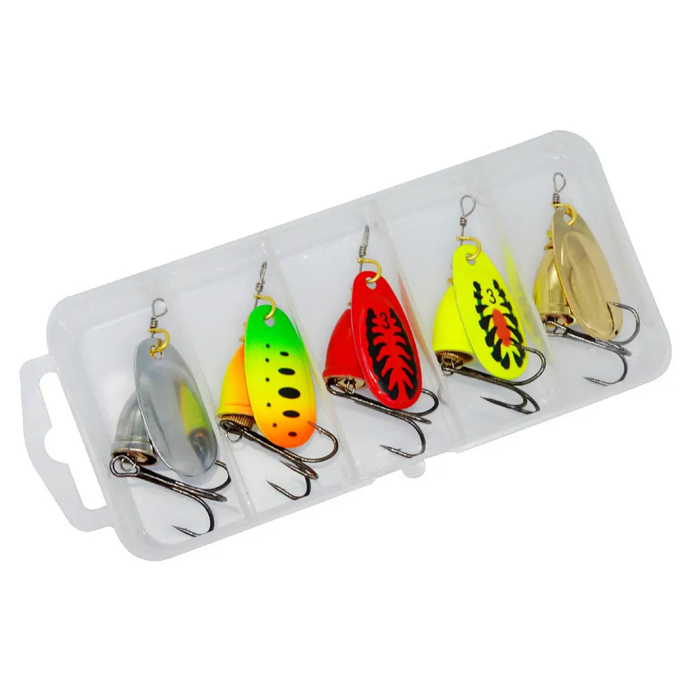 Copper bell metal fishing lure with rotating sequins in seven colour finishes on a blue background.