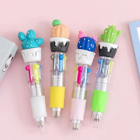 A four-colour ballpoint pen with a press top and a colourful cartoon silicone grip, showing one of five random designs.