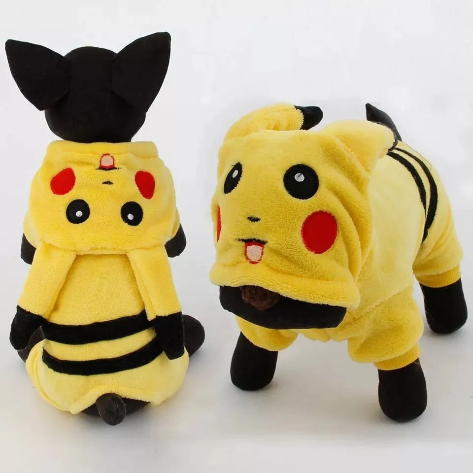 A small dog or cat wearing a cartoon-design fleece coat with a hoodie, suitable for indoor winter wear.