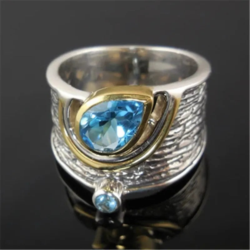 Blue drop-shaped zircon ring with rhinestone inlay on an alloy band, shown in women's sizes 6 to 10.
