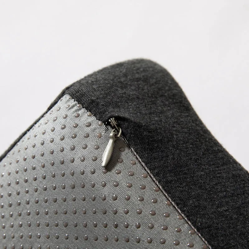 Dark grey memory foam office chair cushion with contoured shape for lower back support on a desk chair.