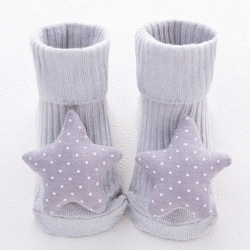 Cotton baby floor socks in various patterns including animal prints, stars, and bows for infants aged 0-3 months