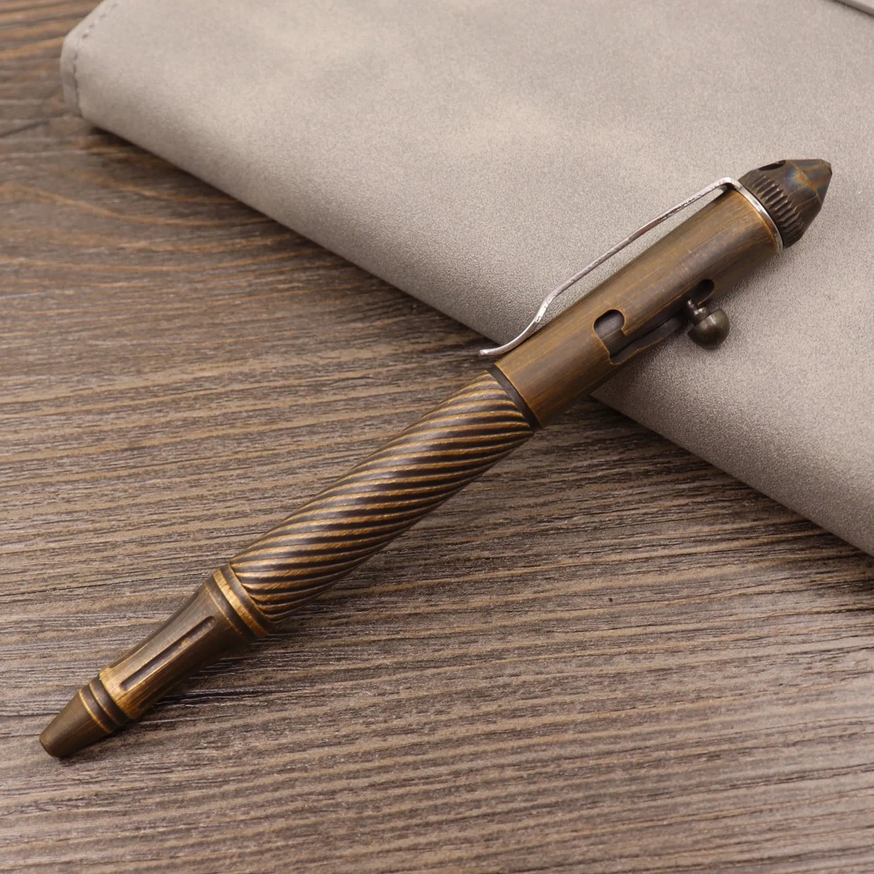 Retro brass tactical pen with bolt action mechanism in brushed natural finish