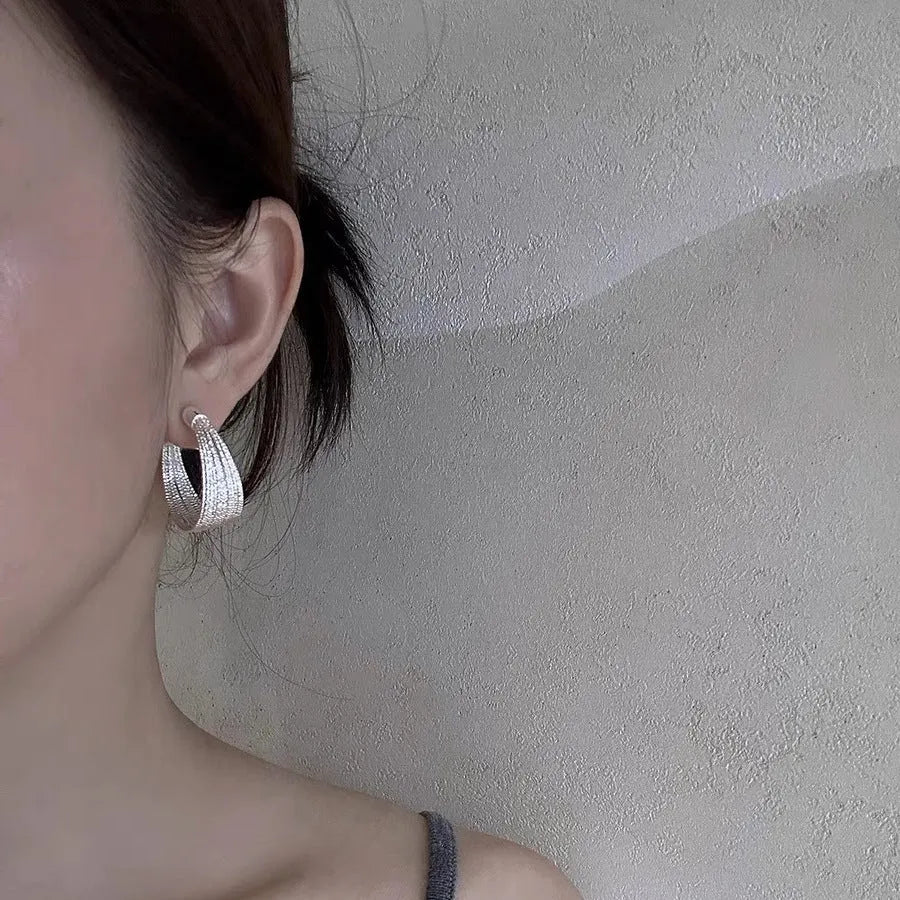 Geometric copper earrings with electroplated silver and gold finishes, including stud and clip-on options