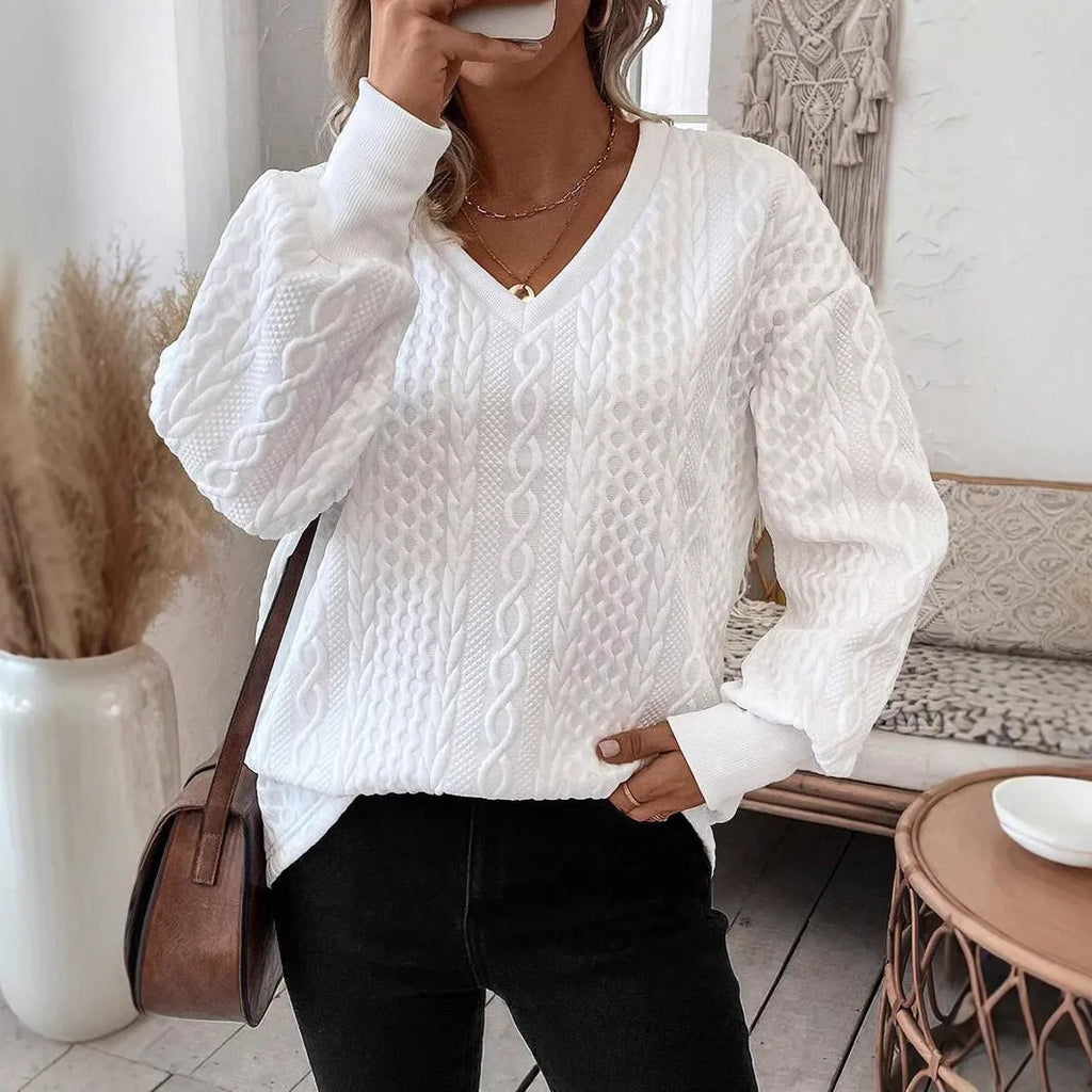 Milky white loose fit long sleeve t-shirt with a 3D pattern on a hanger