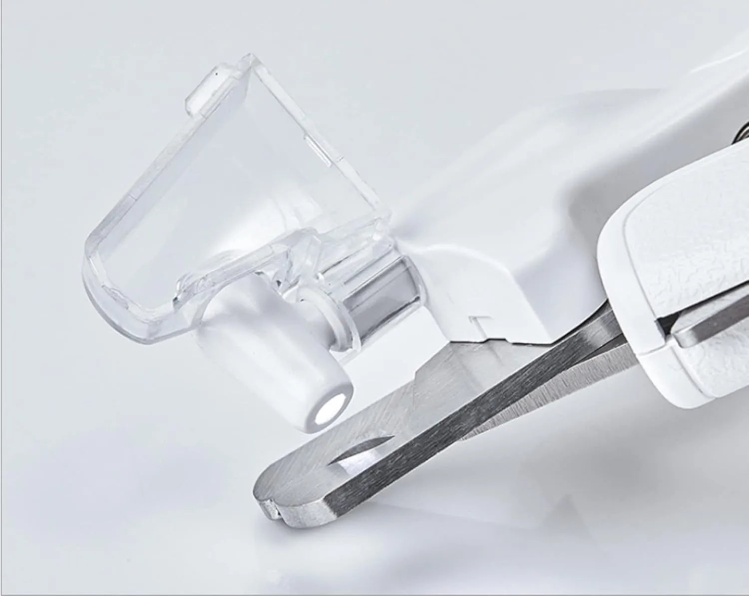 White LED pet nail clippers with open anti-splash guard and nail file on a solid colour background