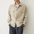 Men's light sand rice colour casual long sleeve shirt with a simple lapel, on a hanger.