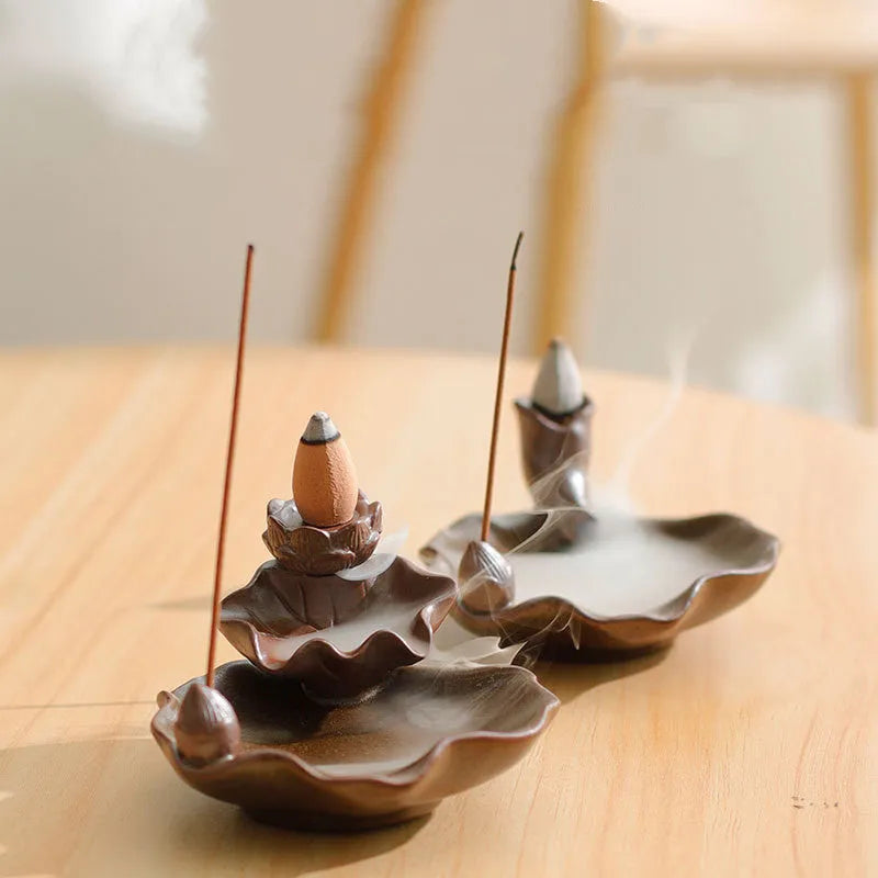Ceramic reverse flow incense burner in purple clay with crystal glaze featuring lotus or plum blossom design