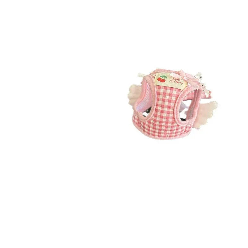 Pink and black small dog harnesses with a hand-holding rope connected at chest and back points.