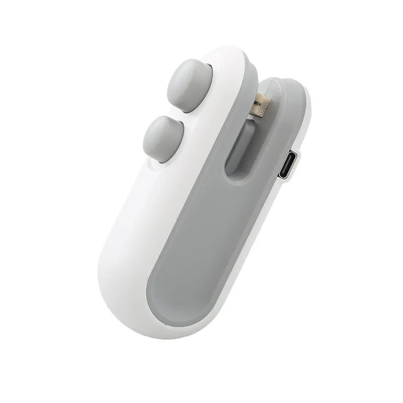White and blue handheld USB rechargeable heat sealer with cutter blade.