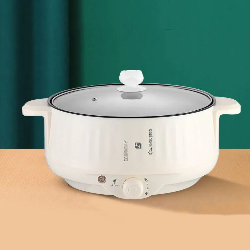 White and green electric cooking pot with integrated heating element and non-stick stainless steel surface
