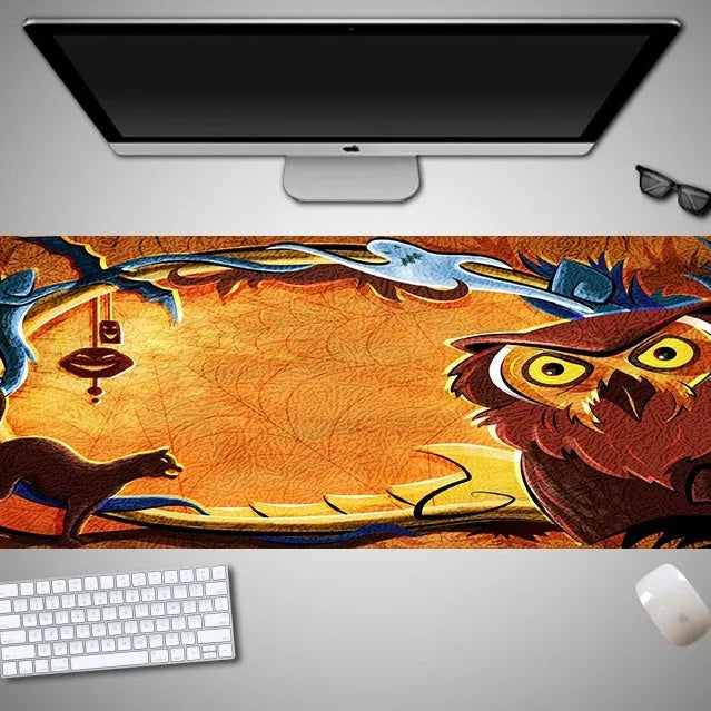 Oversized Halloween-themed computer mouse pad with non-slip rubber cloth base on a desk