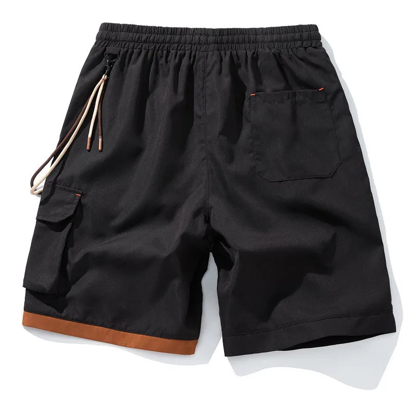 Man wearing loose-fitting black bamboo fibre sports shorts with a straight-leg cropped cut.