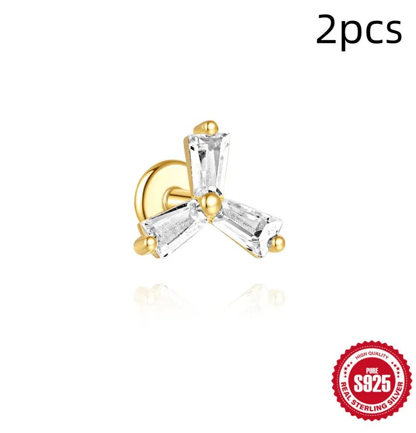 S925 sterling silver stud earrings with zircon inlay in golden geometric designs including clover and crown.