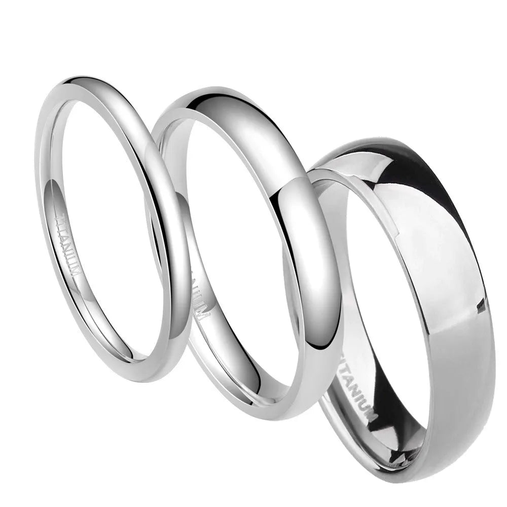 Polished silver titanium steel ring on a finger, showing a minimalist band design.