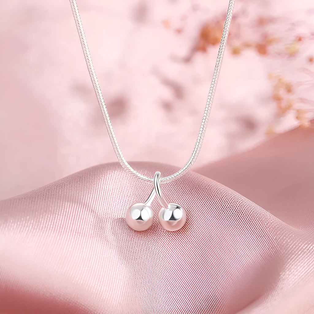 Sterling silver cherry pendant necklace on a snake bone chain, adjustable from 21cm to 50cm.