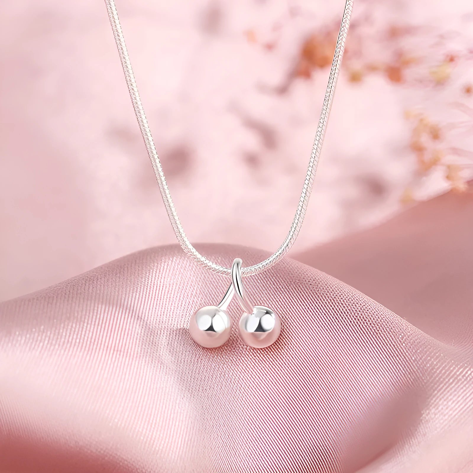Sterling silver cherry pendant necklace on a snake bone chain, adjustable from 21cm to 50cm.