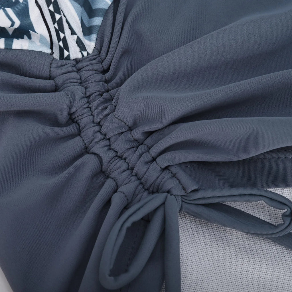 Women's split front bikini swimsuit in picture colour, showing triangle top and high-rise briefs.