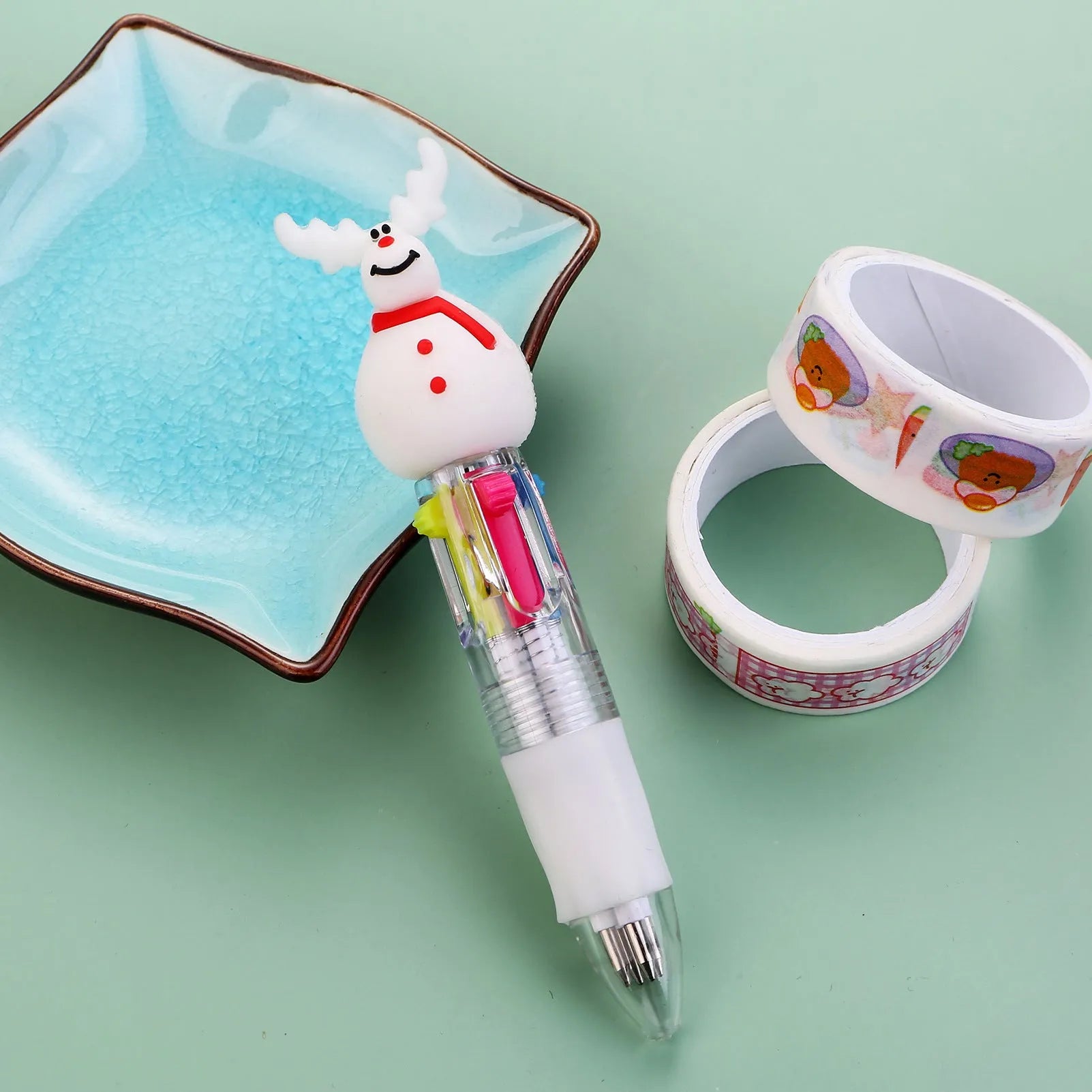 Compact 11cm Christmas four-colour press pen with festive designs including reindeer and snowmen.