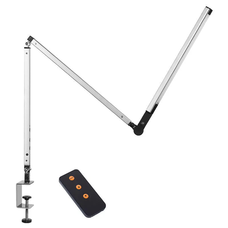 Black adjustable clip-on desk lamp with flexible arm and remote control on a wooden desk