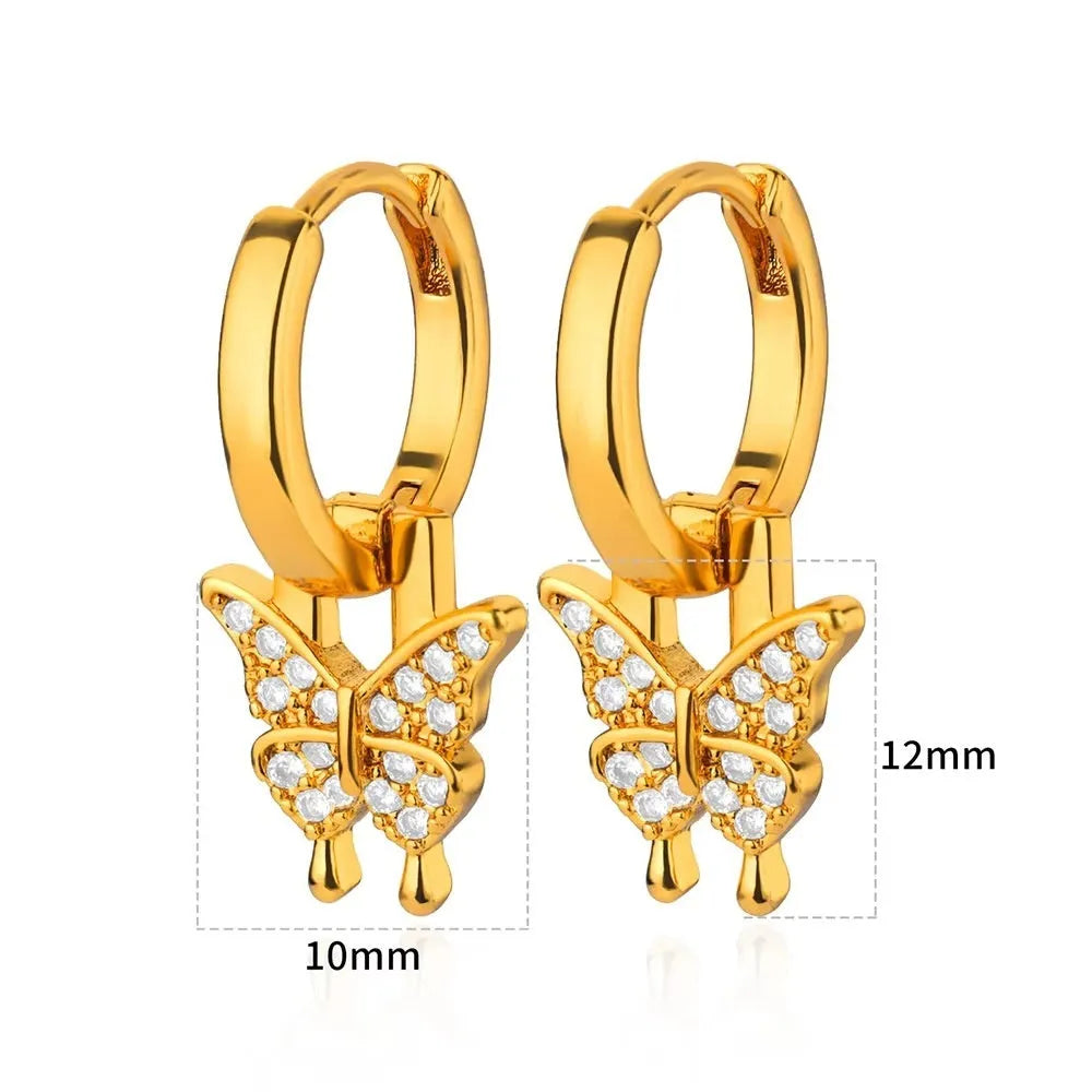 Geometric butterfly-shaped earrings with heart, bow, and star details in copper with a diamond-cut finish.