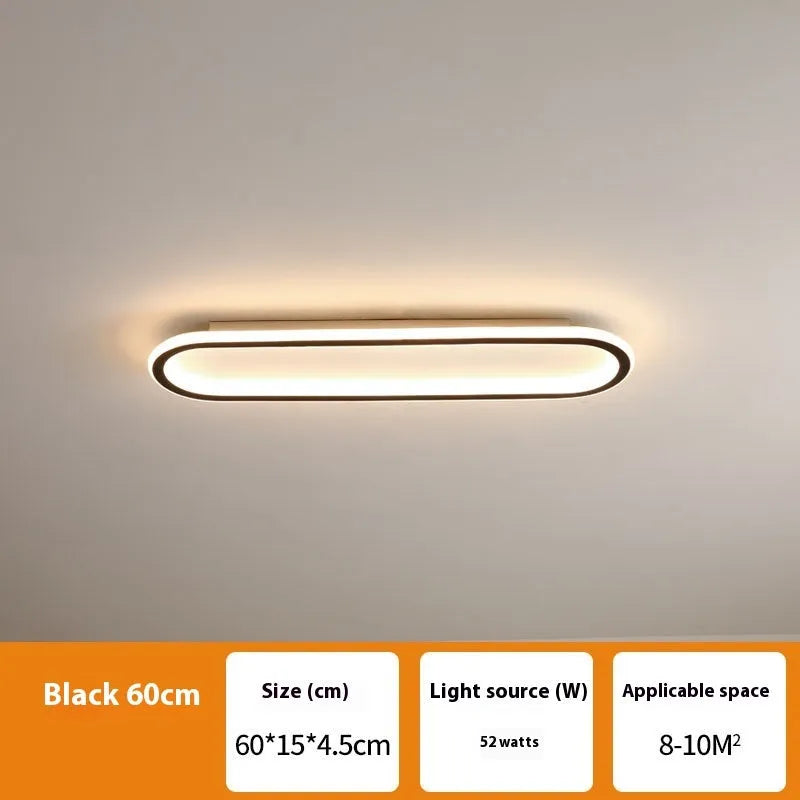 Black minimalist strip ceiling lamp mounted flush on a white ceiling.