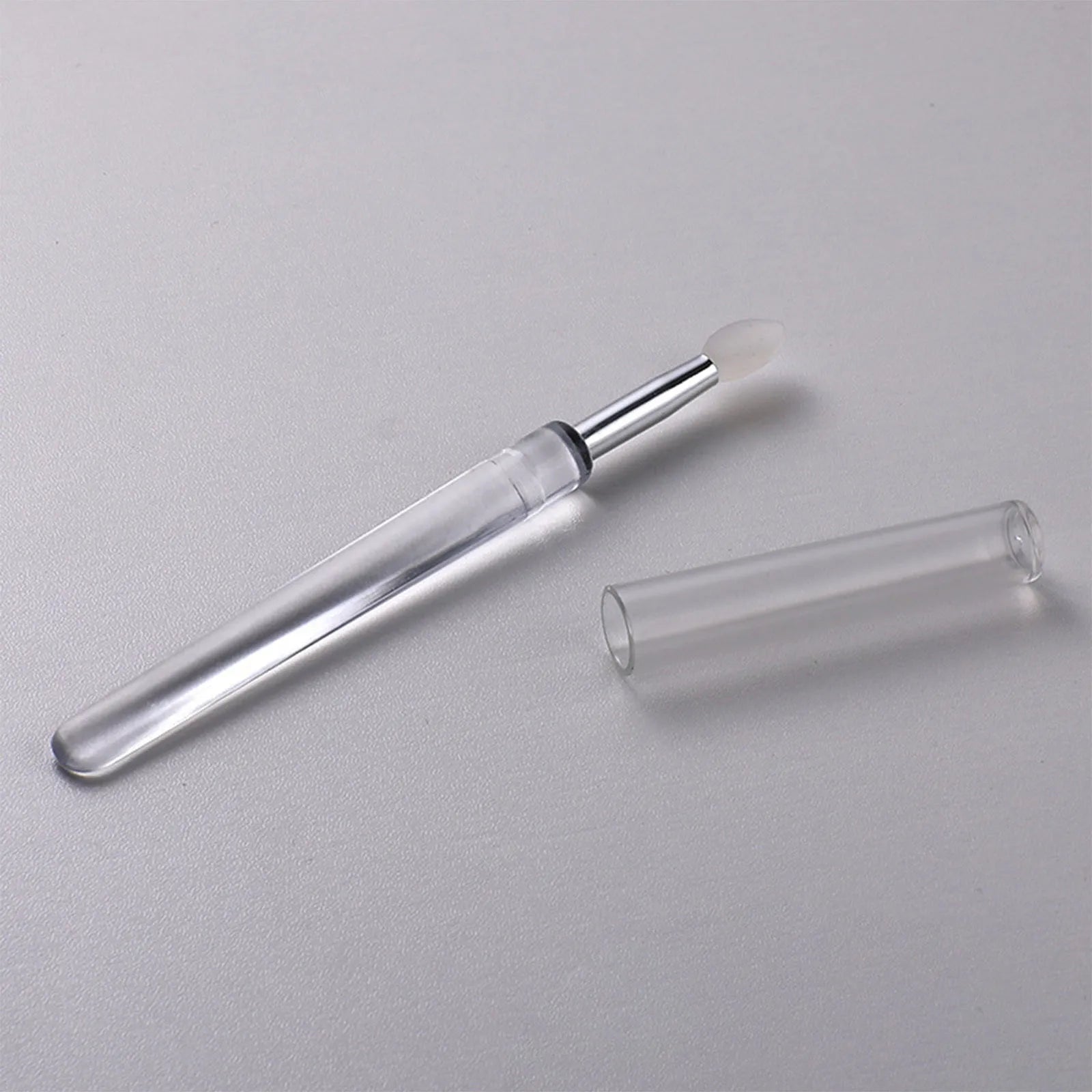Silicone lip brush with protective cap for hygienic lip product application