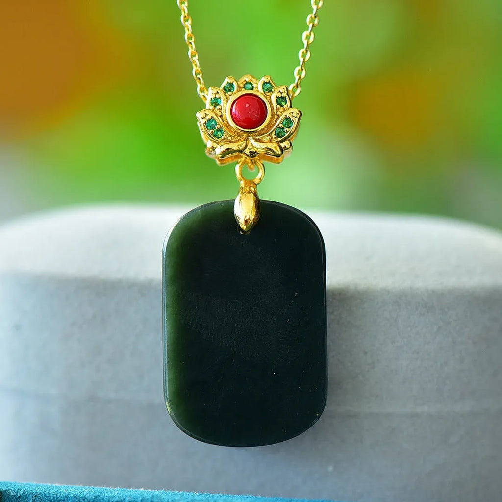 Flat grey Hetian jade pendant with copper wire inlay decoration and ink blue jade accents on a necklace.