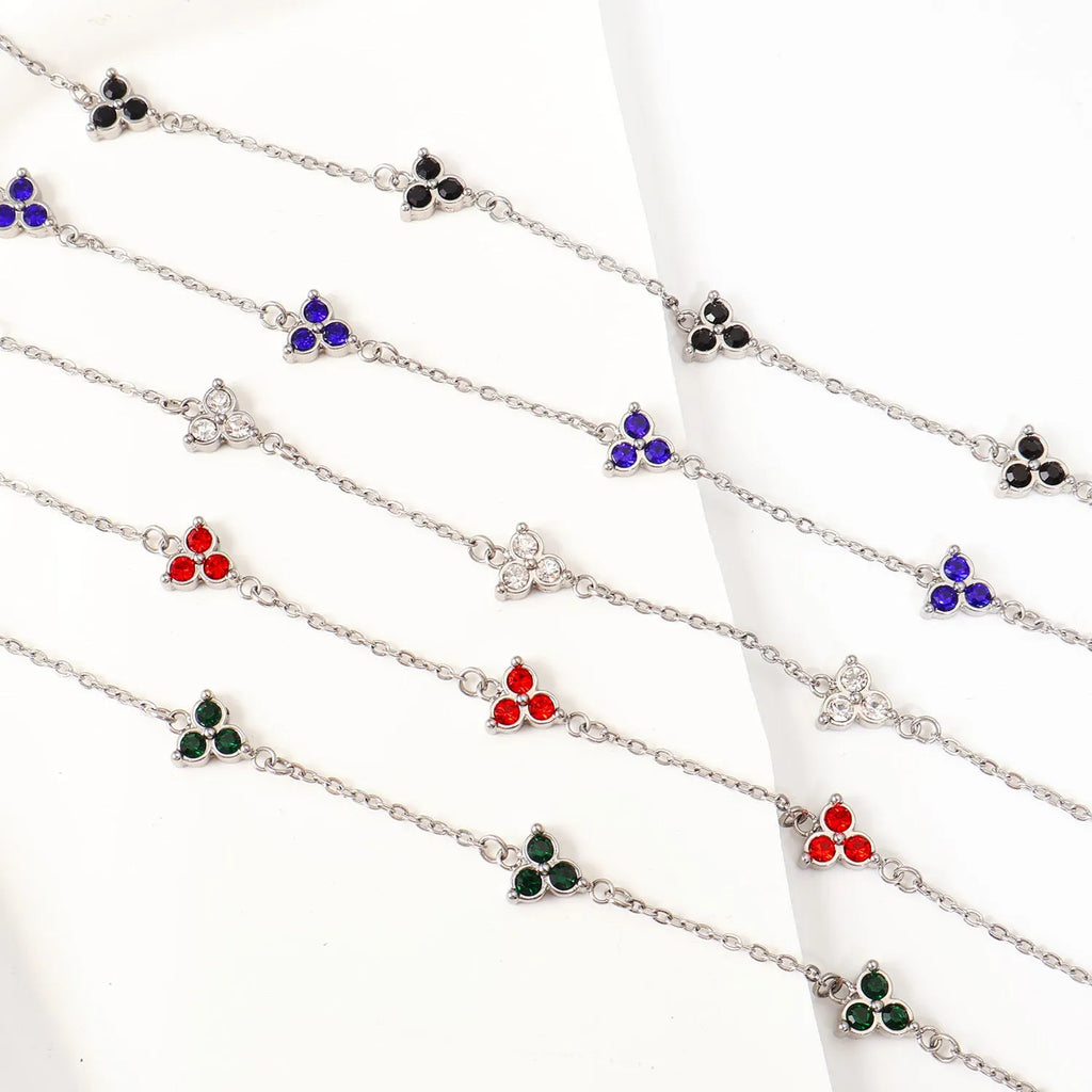 Women's stainless steel bracelet with three triangular charms set with coloured zircon stones.