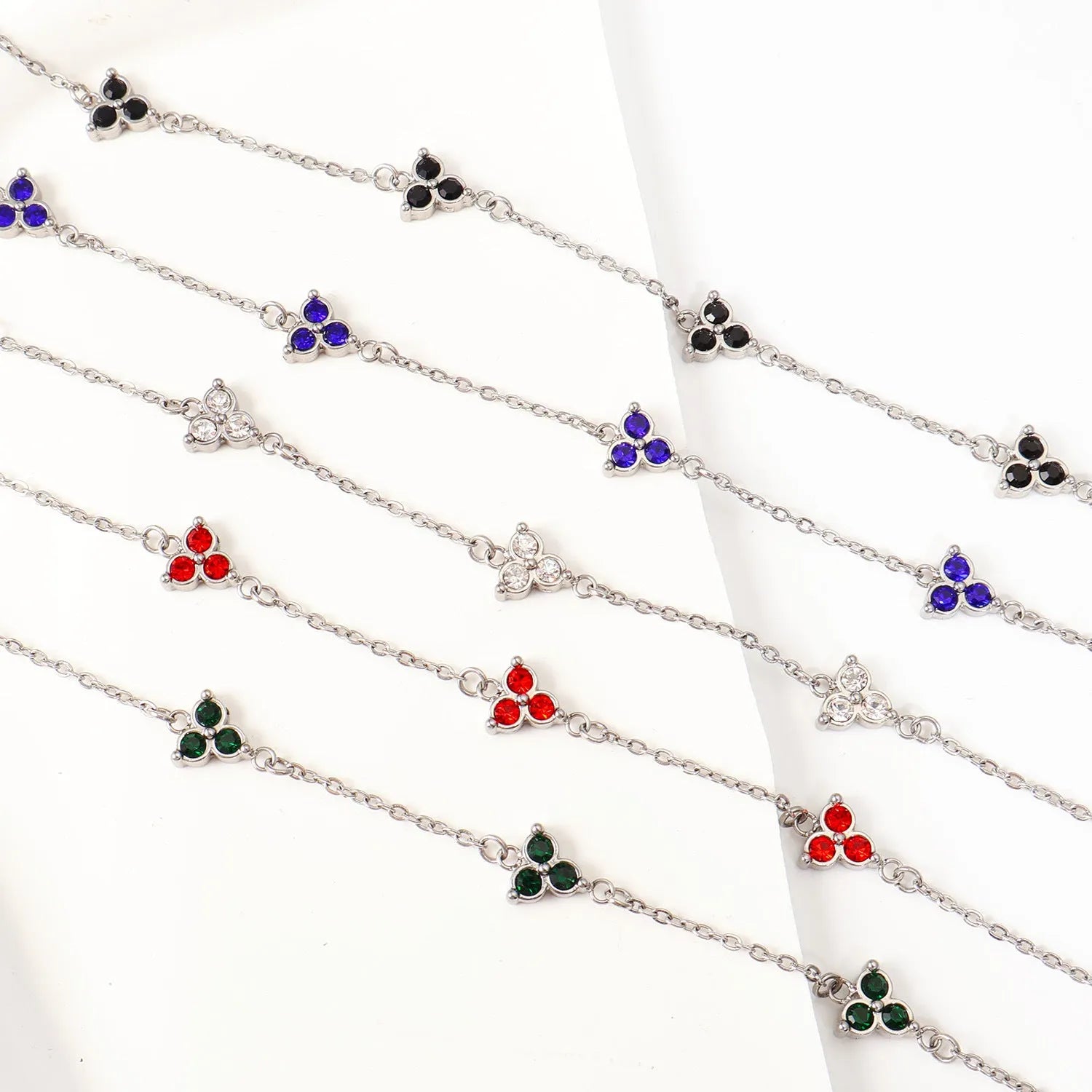 Women's stainless steel bracelet with three triangular charms set with coloured zircon stones.