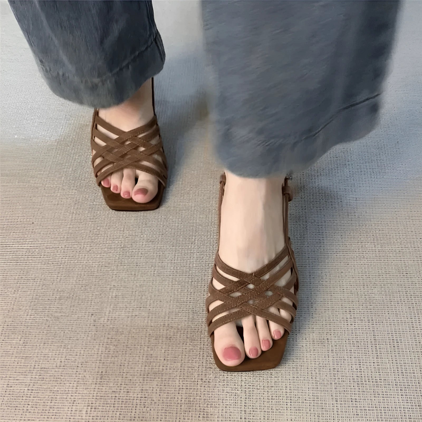 Retro women's sandals with thin cross straps, ankle buckle, and a mid heel on a square toe.