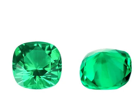 Loose cultivated emerald gemstone in Columbia green colour showing round and fancy cut shapes on a white background.