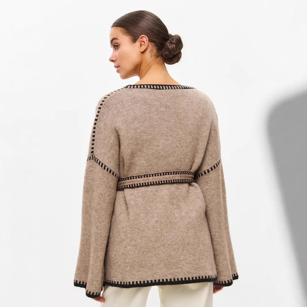 Loose fit knitted cardigan sweater coat in camel colour, showing long sleeves and mid-length hem.