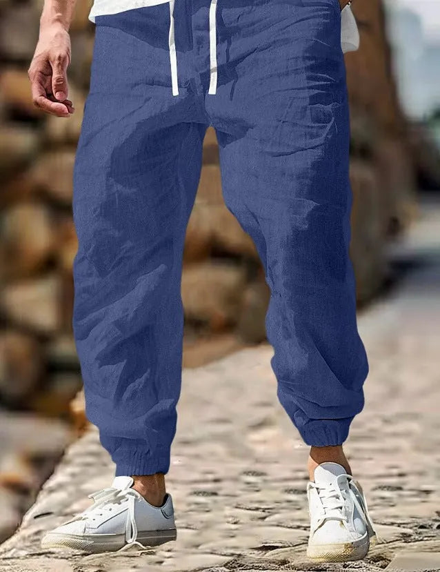 Men's straight-leg cotton trousers in apricot colour with an elastic waistband.