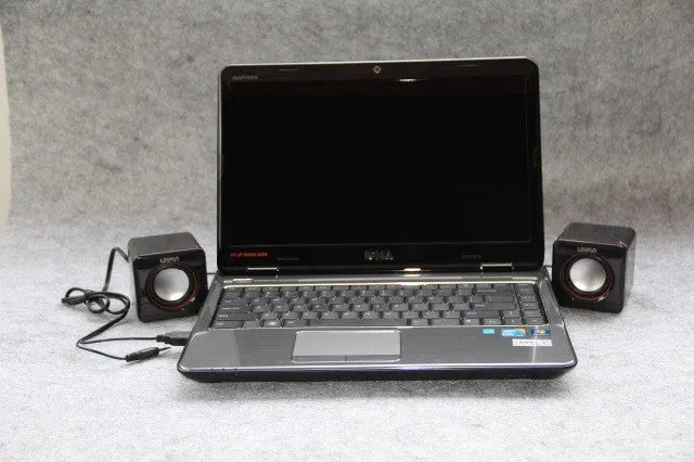 Small black square USB-powered computer speaker for desktop audio enhancement