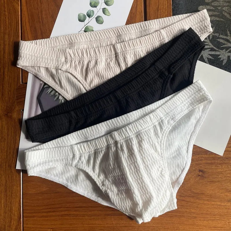 Men's solid colour cotton briefs with a mid waist and triangle design.
