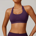 Women's black halter-neck yoga sports bra with removable padding on a mannequin.