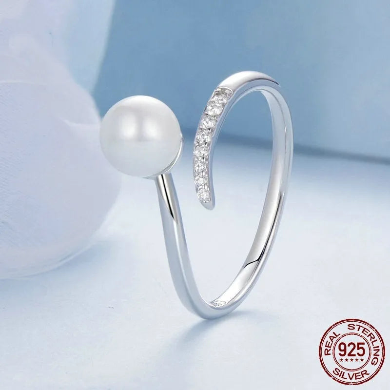 Sterling silver adjustable pearl ring with natural shell pearls on open loop design