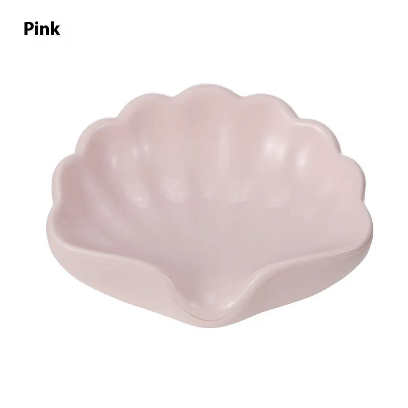 White or pink plastic shell-shaped soap dish for bathroom sink storage