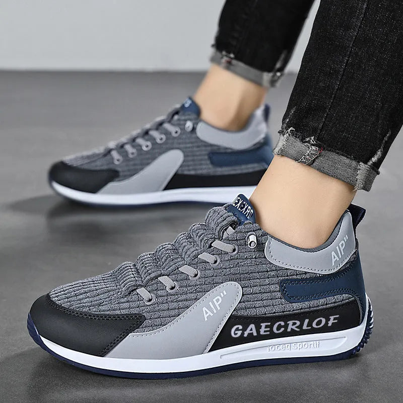 Men's lightweight mesh running shoe in green or grey with lace-up front and round toe