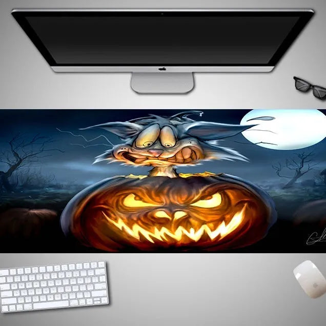 Oversized Halloween-themed computer mouse pad with non-slip rubber cloth base on a desk