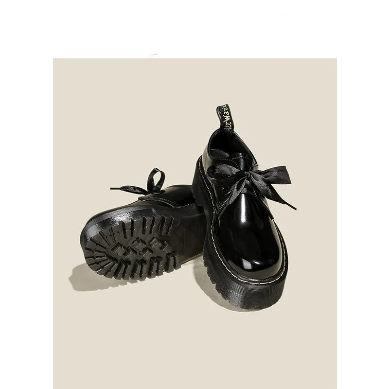Women's thick soled leather shoes with cross strap design and lace closure in black colour