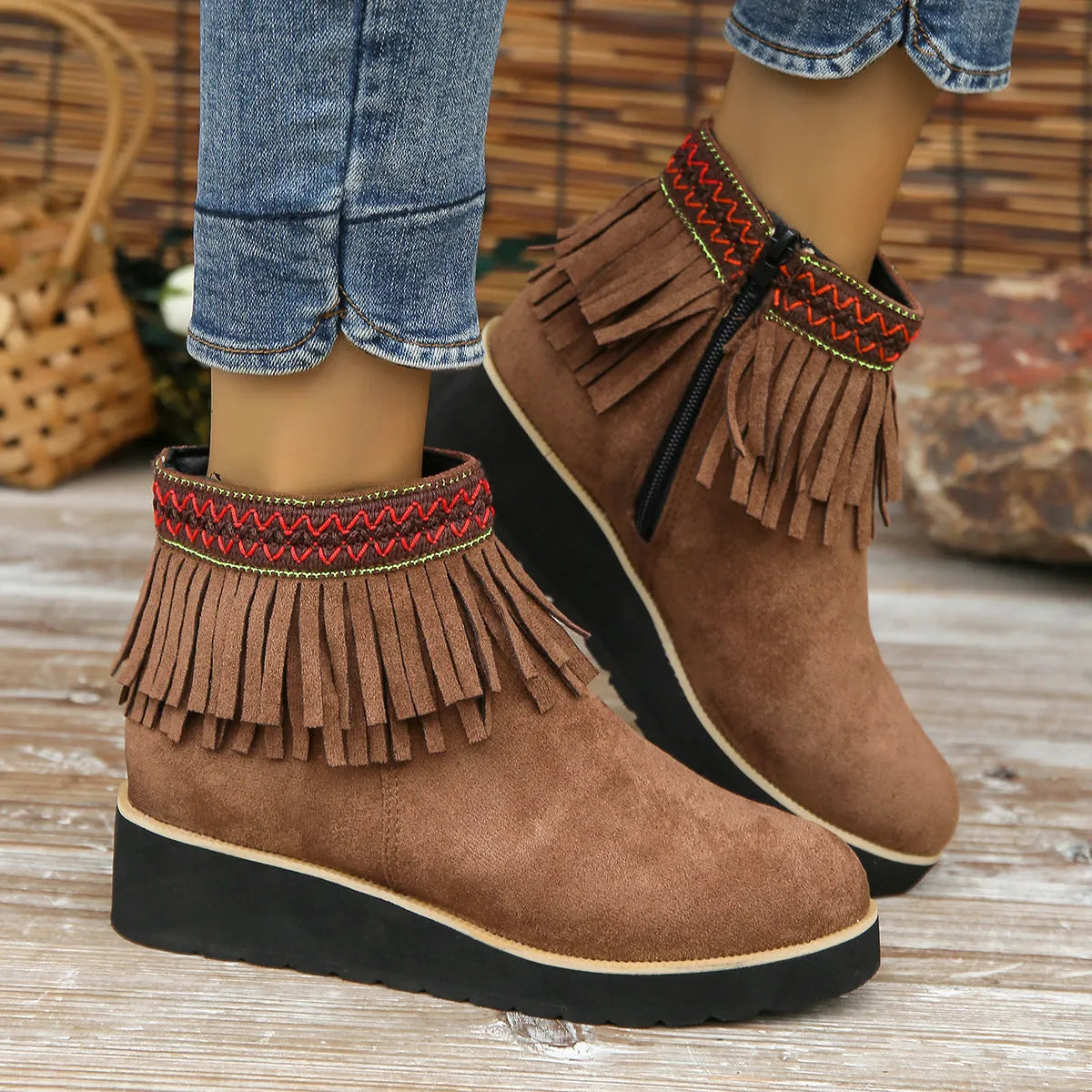 Womens dark brown suede wedge ankle boots with side zip and tassel detail on a thick rubber sole.