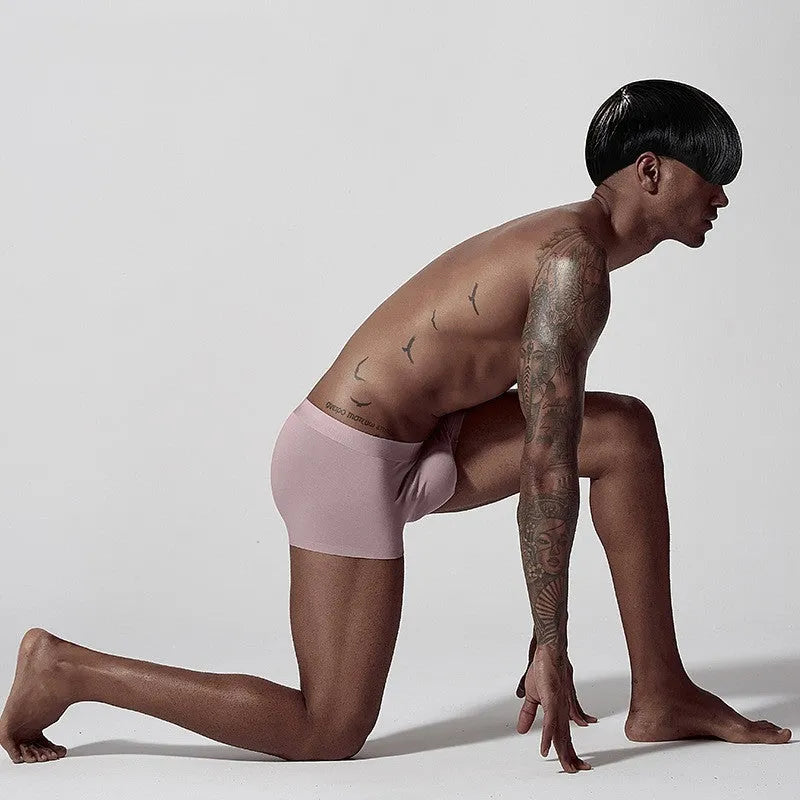 Men's seamless one-piece modal underwear in green, showing mid-waist fit and solid colour design.