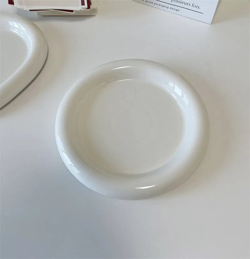White ceramic chubby toot plate with doodle design, shown in bear and round styles.