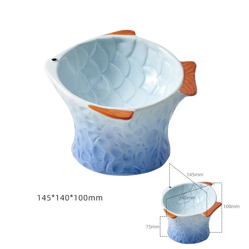 Set of four blue fish-shaped ceramic cat bowls with tilted design and elevated base