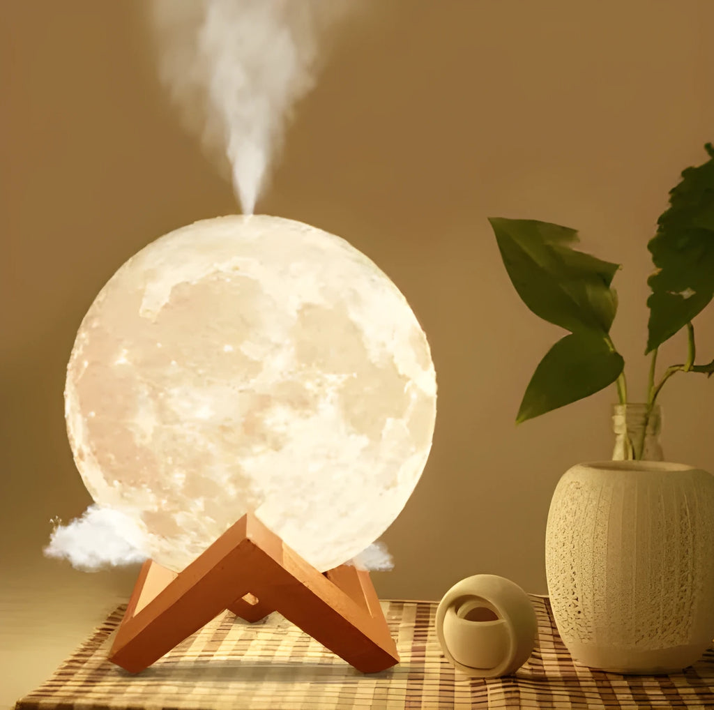 White spherical lunar humidifier night light with USB charging cable on a wooden surface.