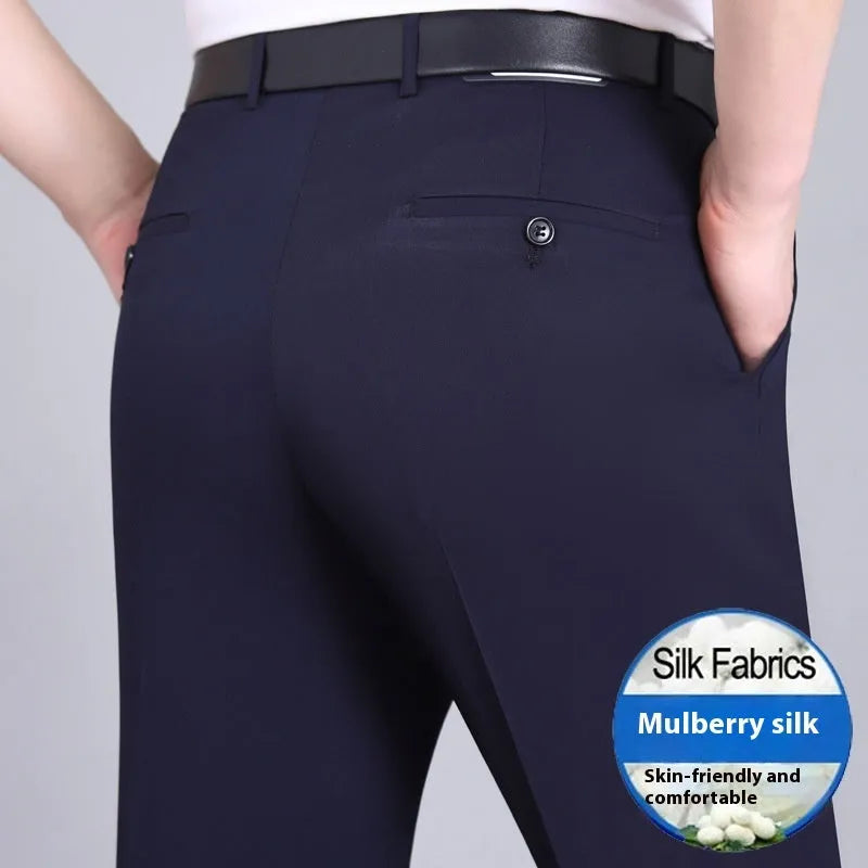 Man wearing black straight-leg high-waisted non-iron business trousers made from a Mulberry Silk blend fabric.