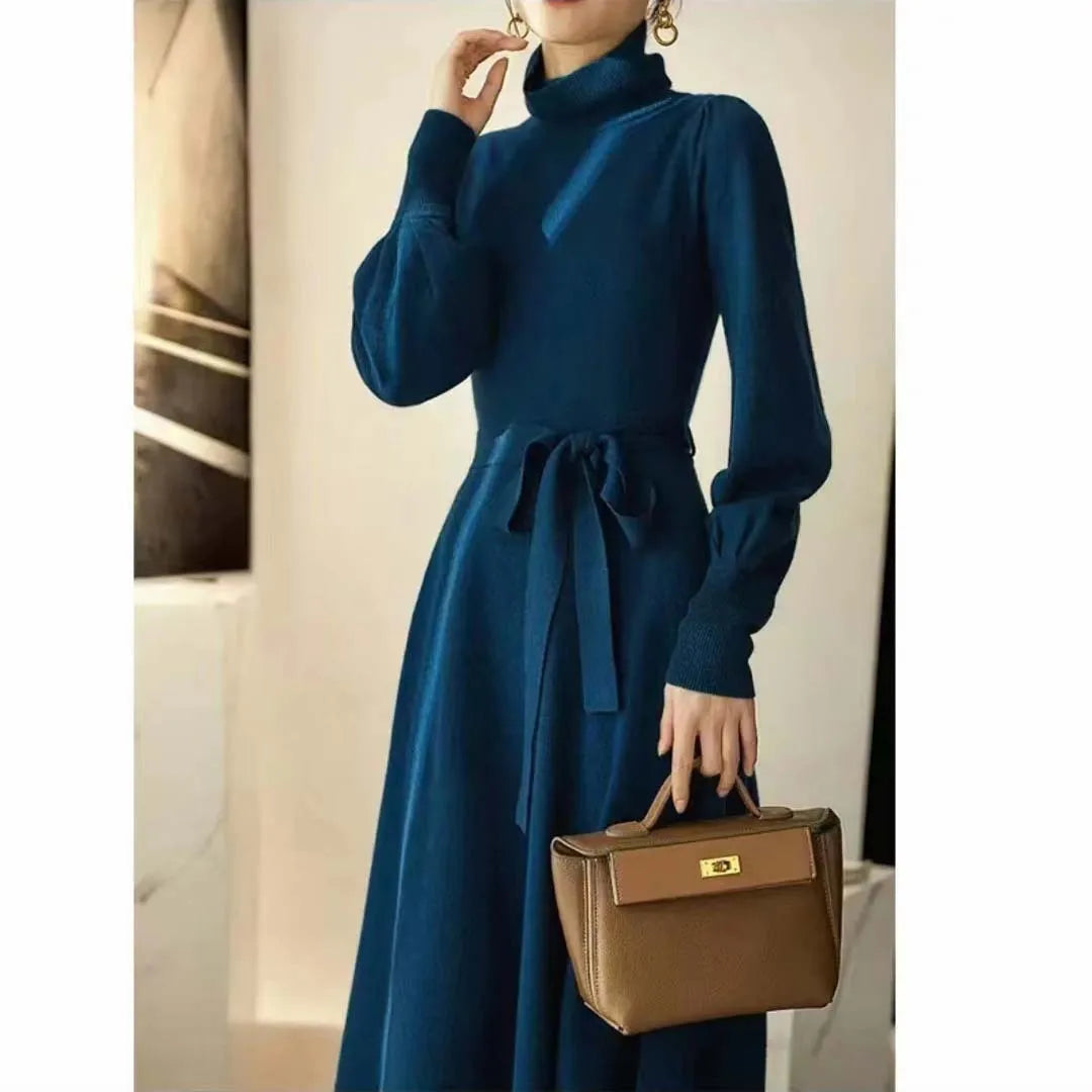 Women's knitted turtleneck dress with long sleeves, elastic waist, and a loose A-line skirt in a solid colour.