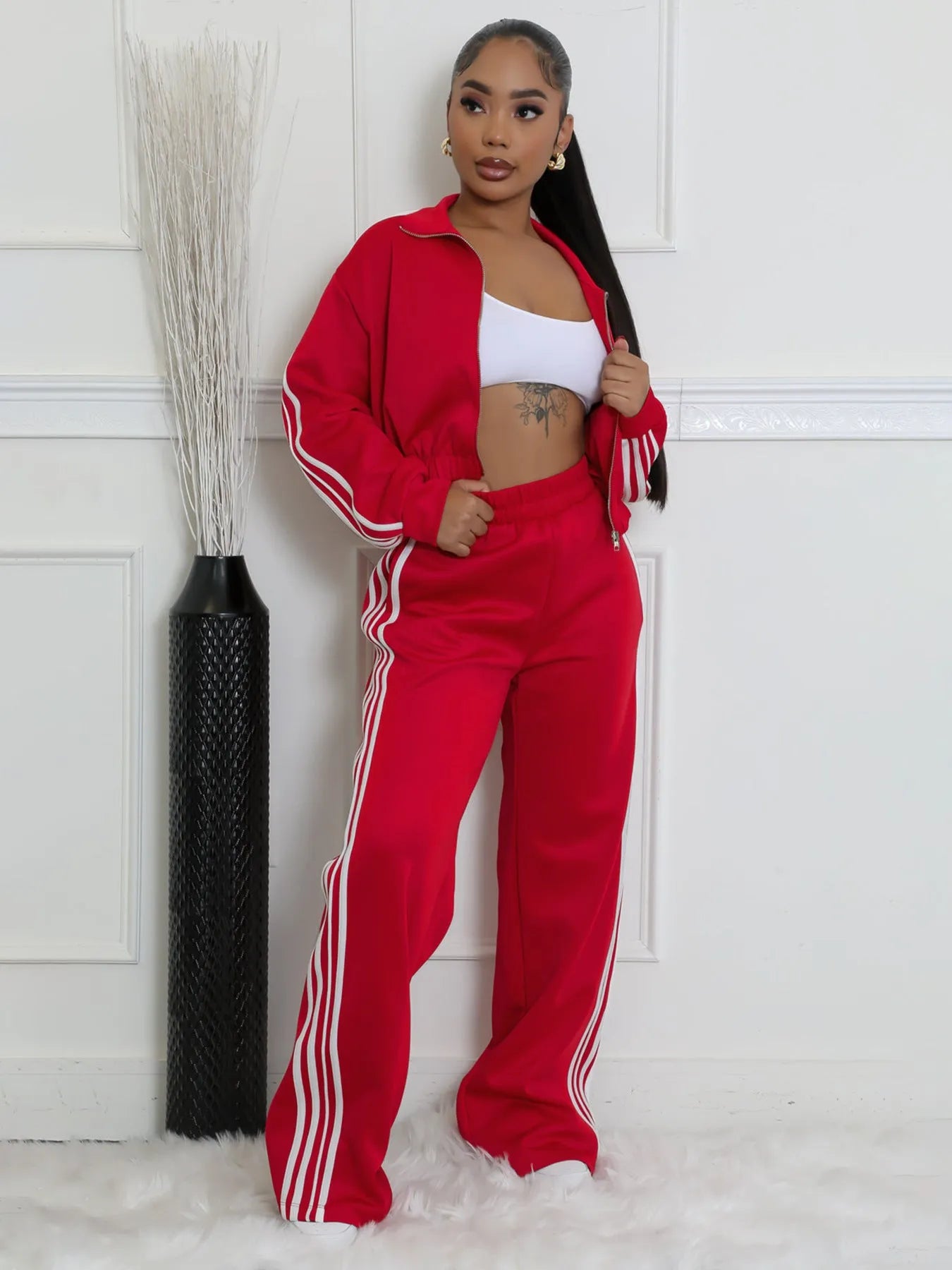 Grey striped streetwear two-piece set featuring a sweater with regular sleeves and matching trousers.